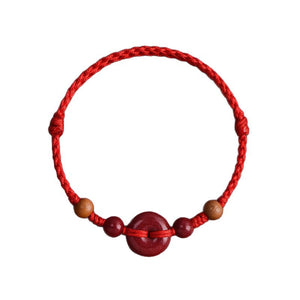Red String Bracelet with Cinnabar Safety Buckle on a white background