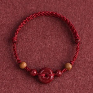Red String Bracelet with Cinnabar Safety Buckle on a red background