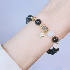 A woman wearing Black Obsidian Bracelet with Heart Star Flower